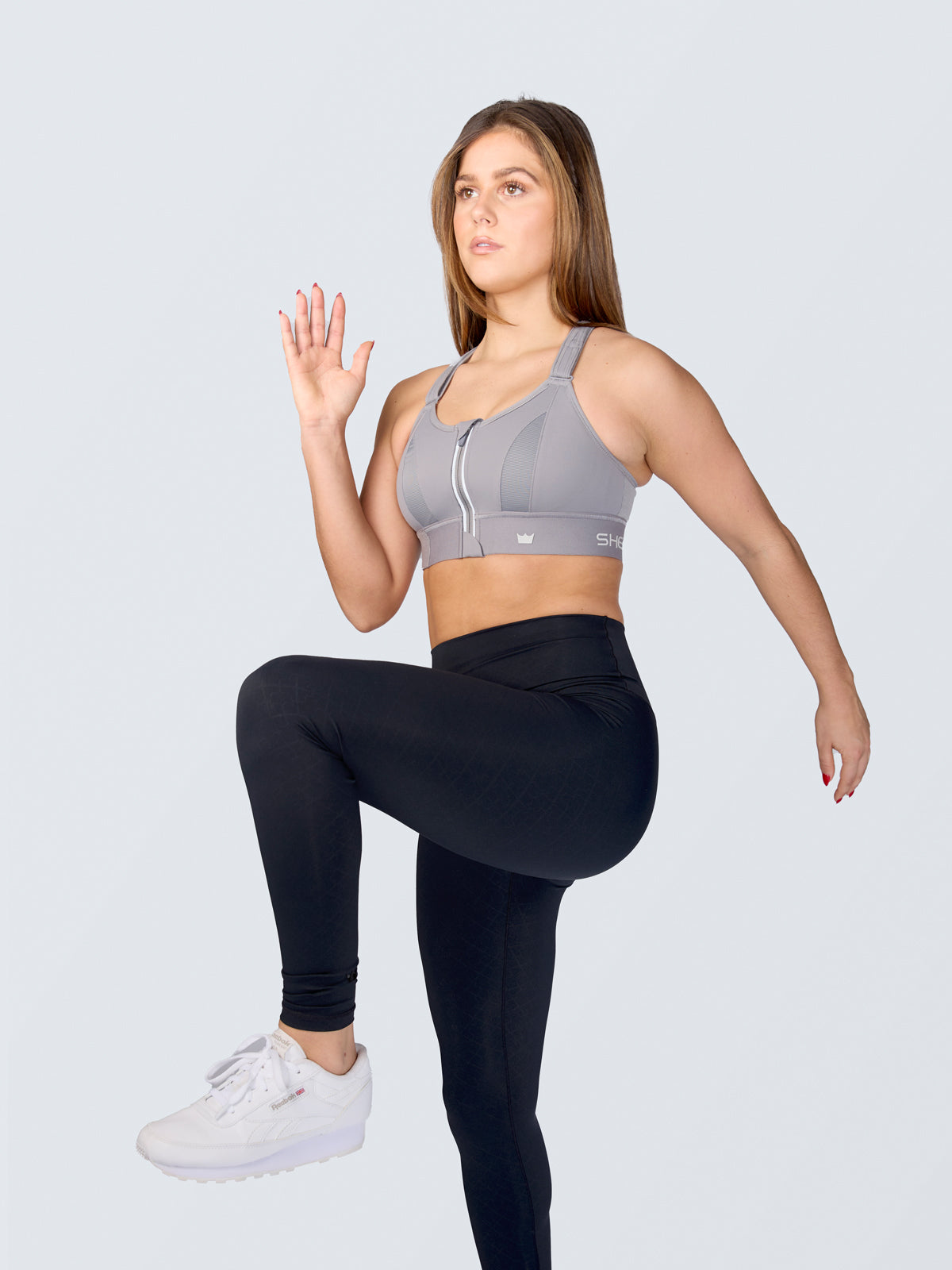 Active slim woman in sport clothes does pilates exercises and