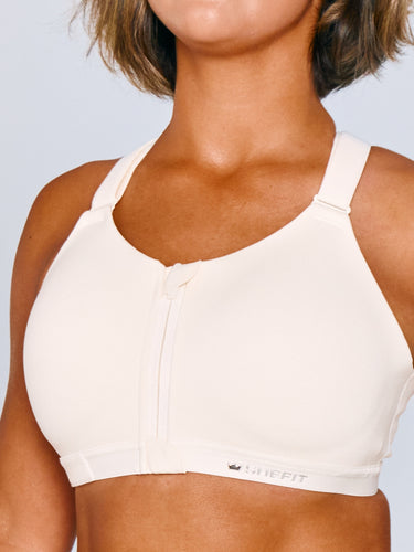 Women wearing Emerge Sports Bra in Ivory Drive. Women is wearing a size luxe.