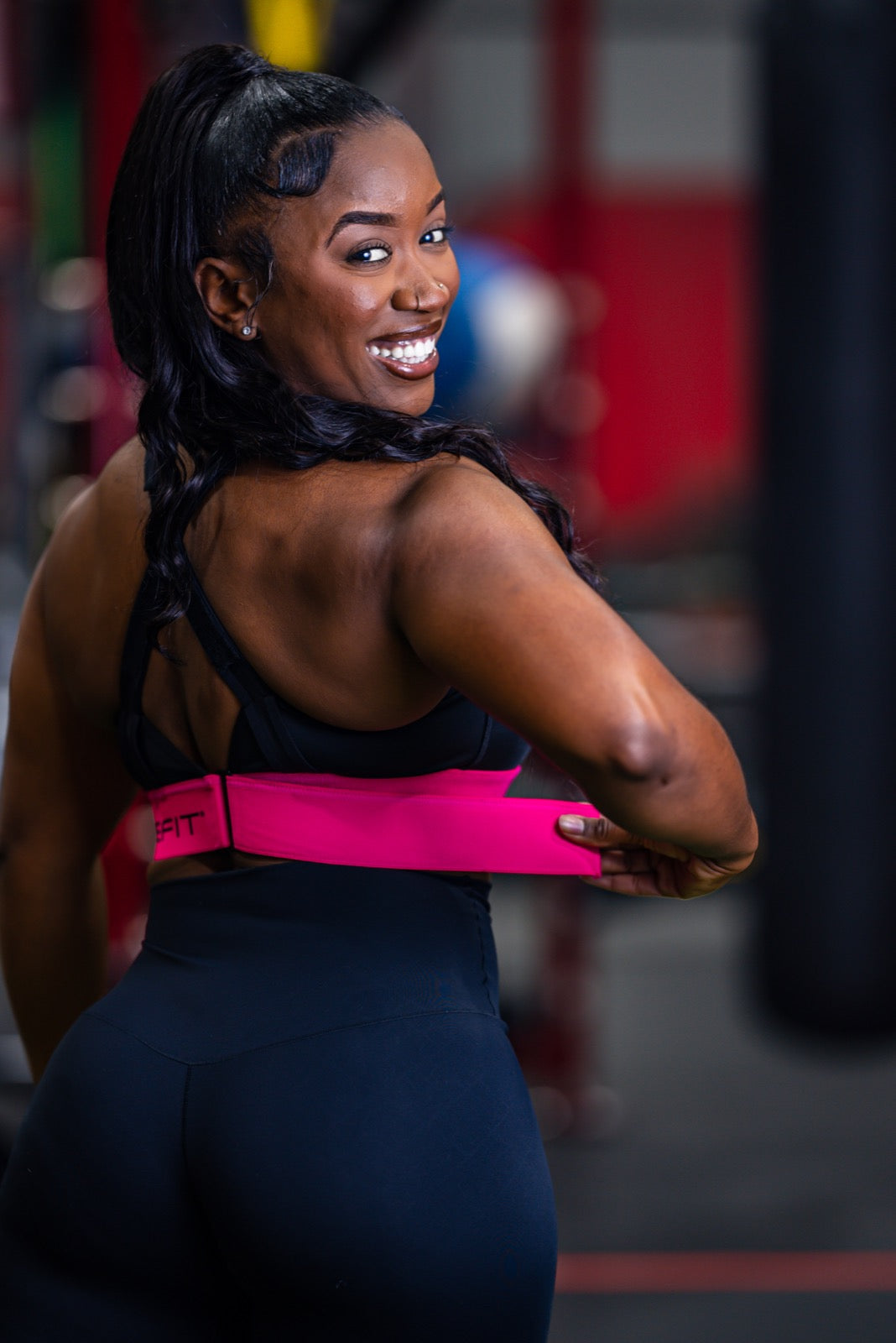 Creator demonstrating the adjustable pink SHEFIT rib band