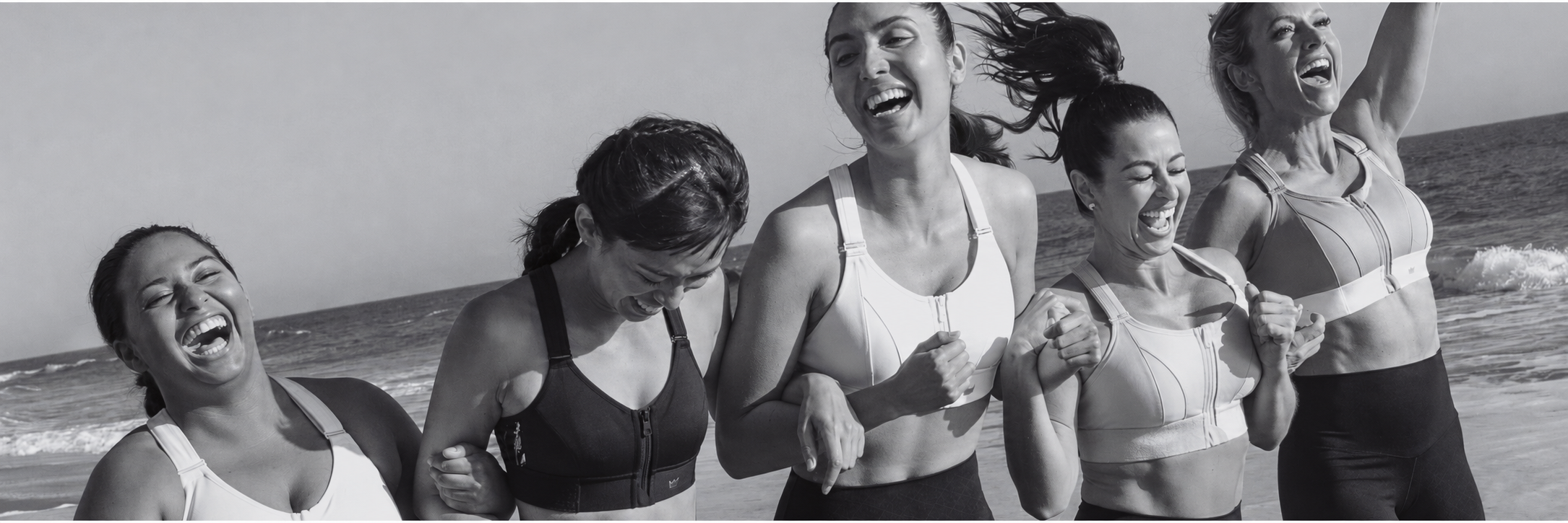 Women enjoying a run together on the beach in SHEFIT sports bras